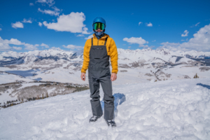 man facing camera wearing Arcteryx ski bibs